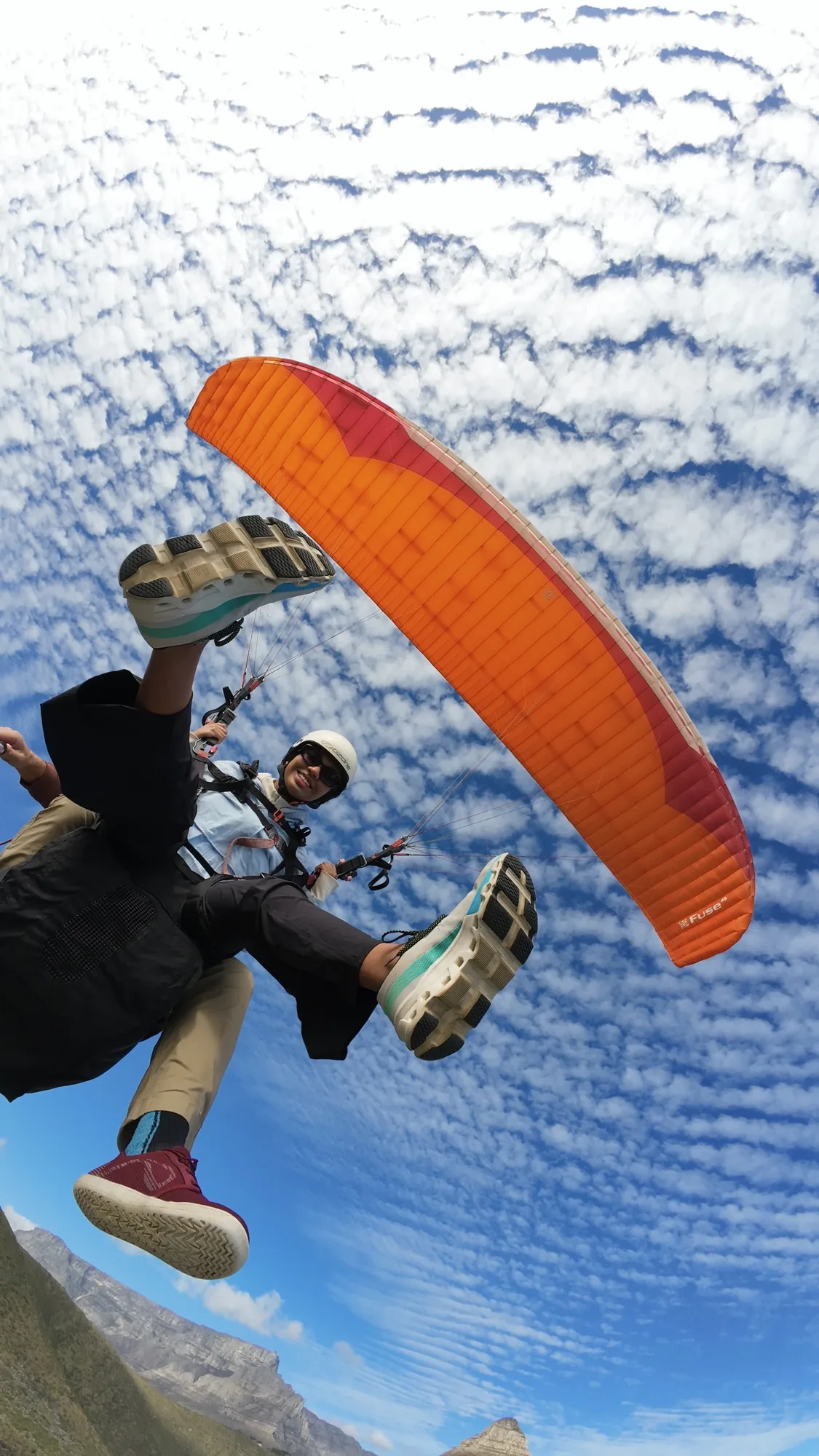 First-time tandem paragliding passenger above Cape Town